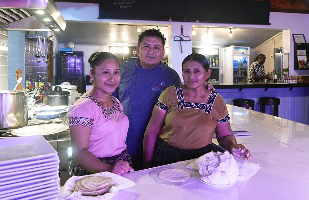 Maya Mike poses with his wife, and his mother as they prepare to host Pibil Night